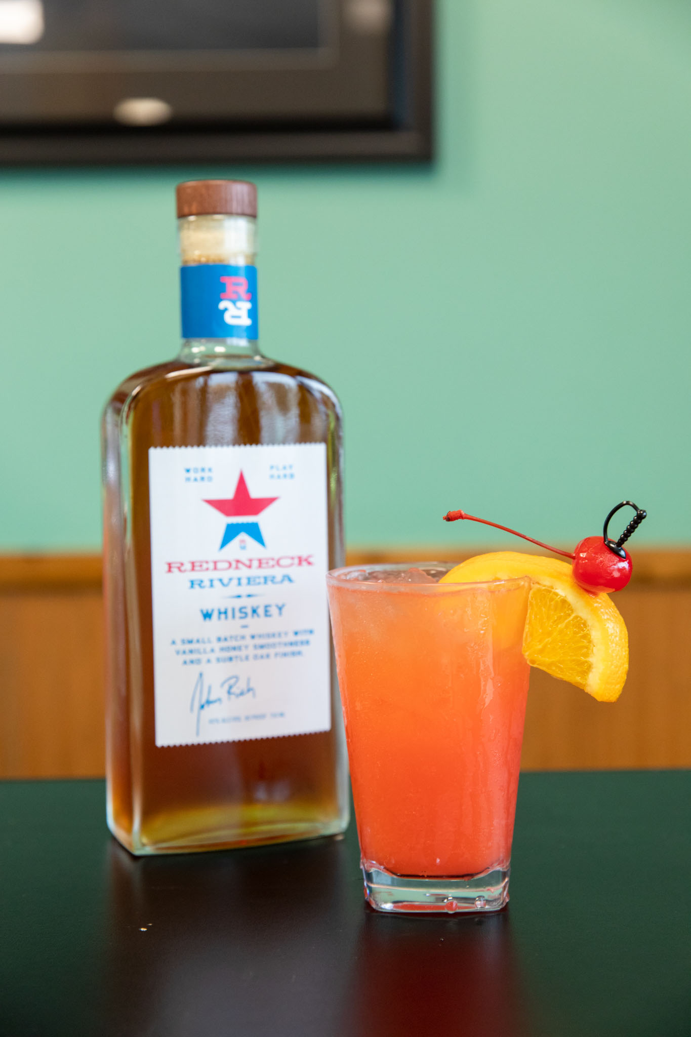 Redneck Riviera Whiskey bottle with a vibrant cocktail