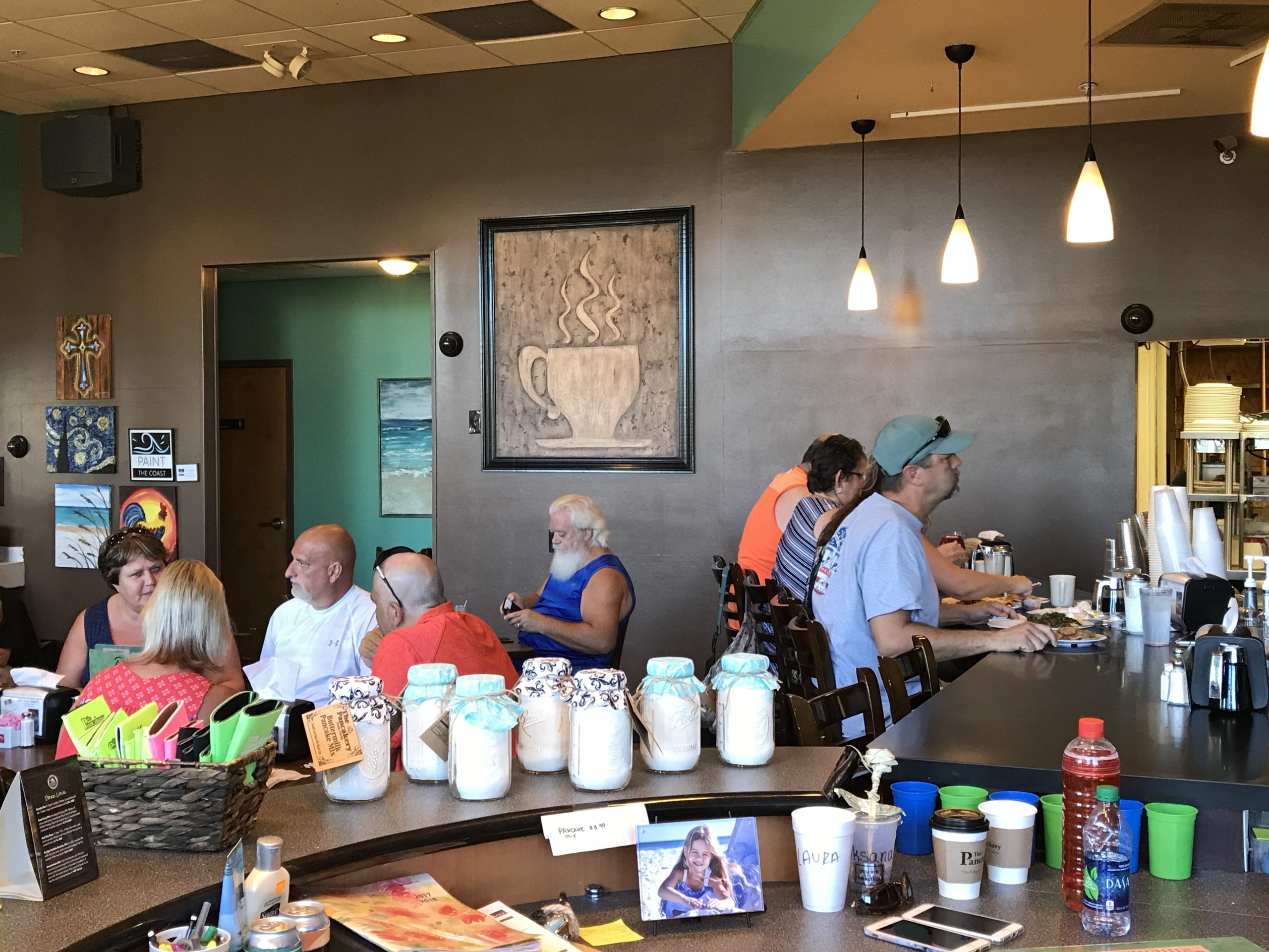 A cozy breakfast café with customers seated at the counter